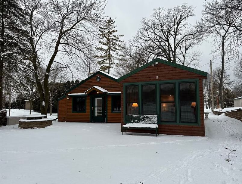 exterior of the Charming Log Cabin on a private spring lake in Fond du Lac, Wisconsin