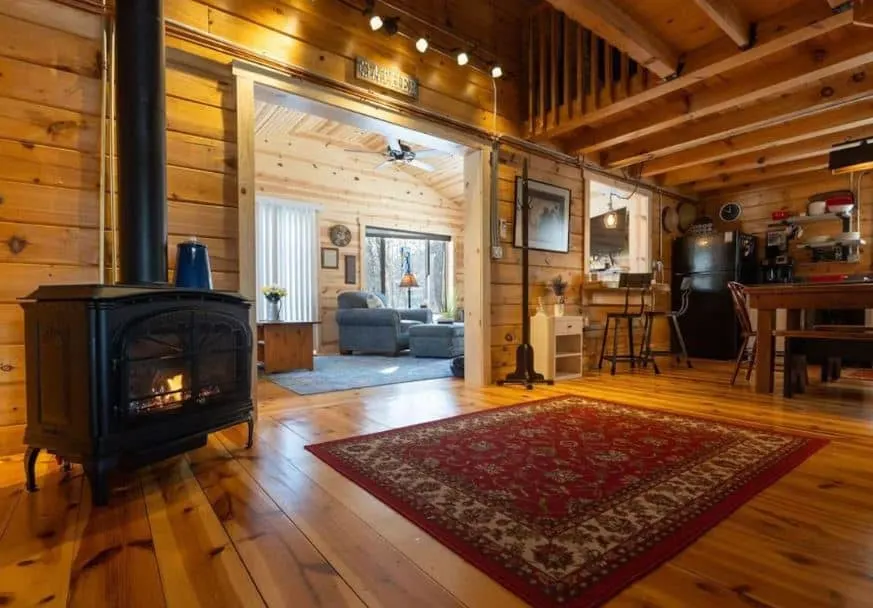 fire place in a wooden living room at the The Cabin on Hidden Creek with Hot tub in Ferryville, Wisconsin
