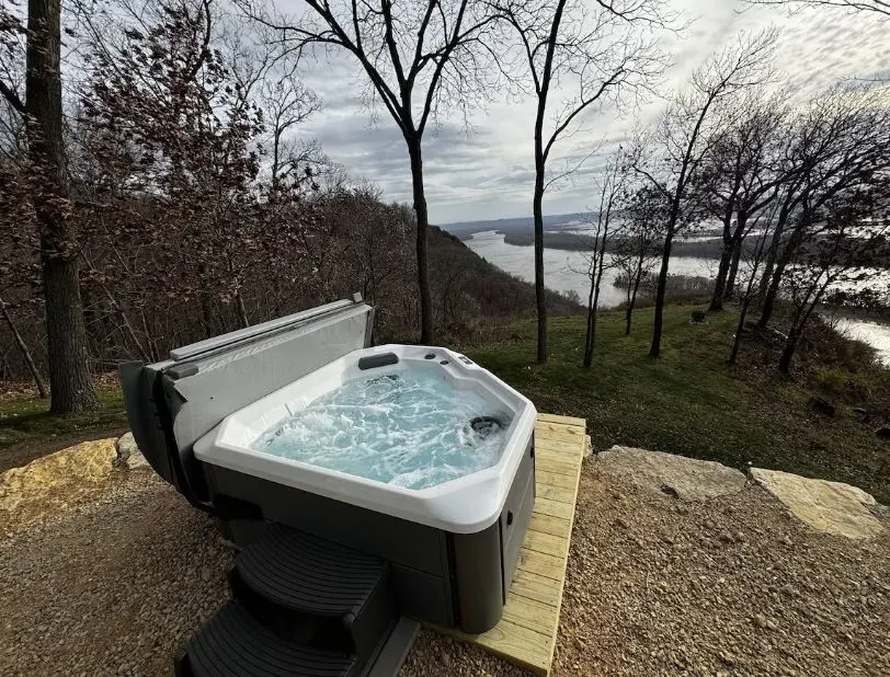 hot tub with a view of the river at Paradise Point Sleeps 4 HOT TUB in De Soto Wisconsin - 15 Gorgeous Wisconsin Honeymoon Cabins