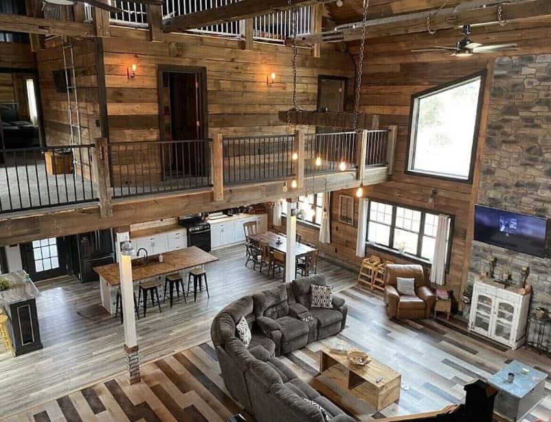 huge living room with sofa, open space kitchen, sitting are at Barn House with hot tub in Merrimac, Wisconsin