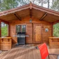 a cabin seen from the front with porch and grill, Small Cabin Rentals Wisconsin