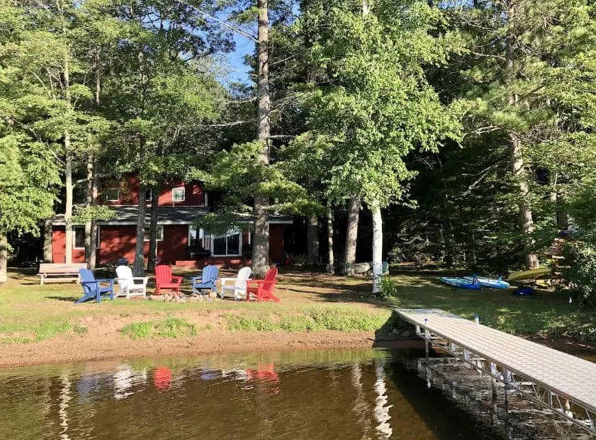 view from the lake of the Fully Renovated Lake House with flat lot, dock & beach in Hayward, Wisconsin