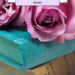 a pin with 2 Photography Coffee Table Books and on top a pink rose