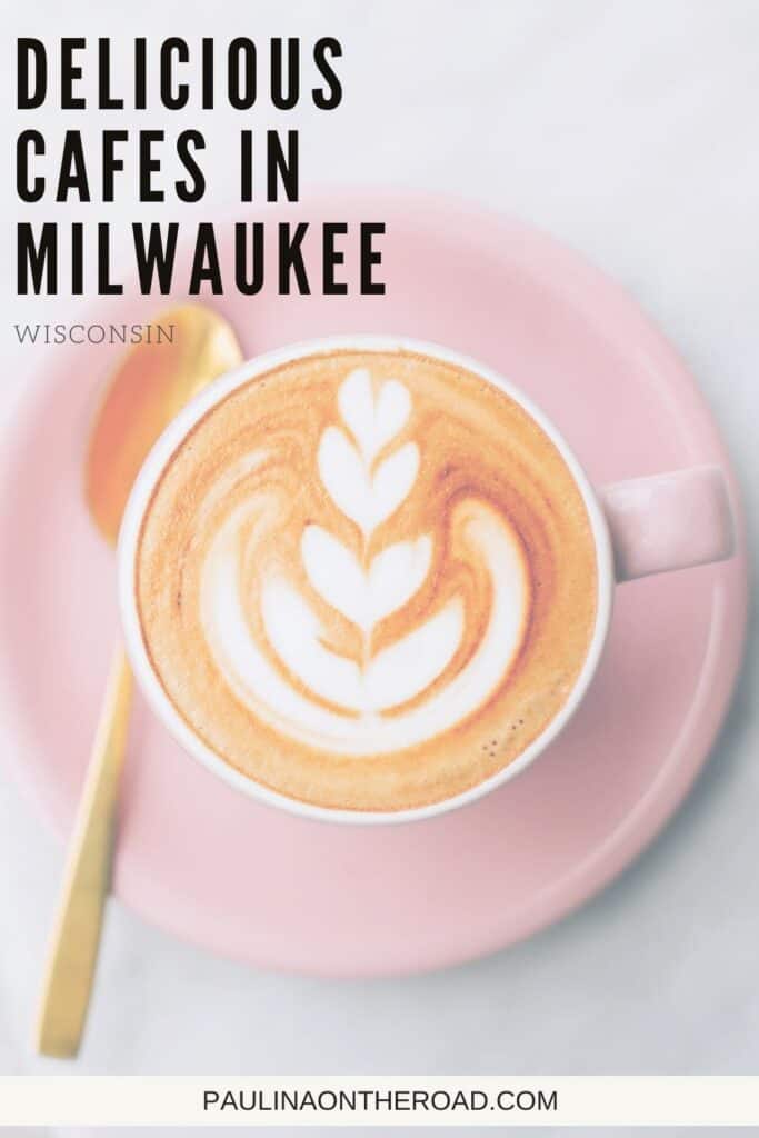 Pin with image of an overhead shot of a cup of coffee with a pattern drawn in the white foam on top with a small wooden spoon nearby, caption reads: Delicious Cafes in Milwaukee, Wisconsin from paulinaontheroad.com