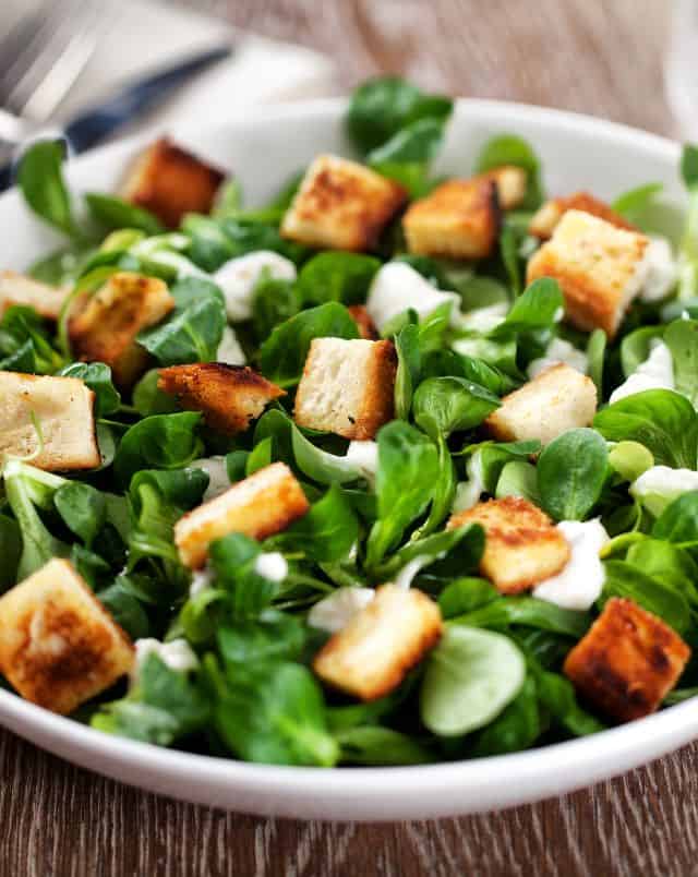 Top Milwaukee cafe shops, Close up shot of a caesar salad with crunchy bread croutons sitting on top of a pile of vibrantly green salad leaves