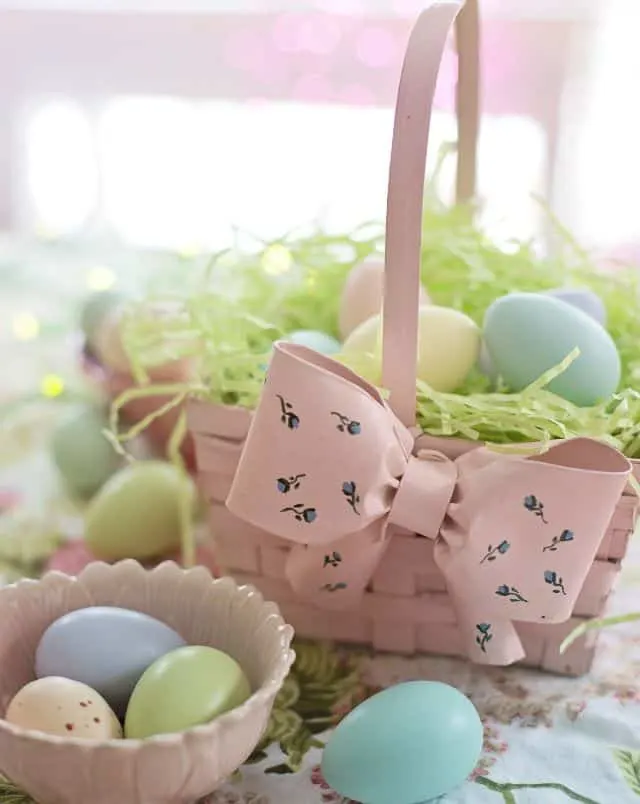 Wisconsin Dells March events, Multi-colored Easter eggs displayed in a small ceramic bowl and in a matching basket with a large bow full of shredded green paper
