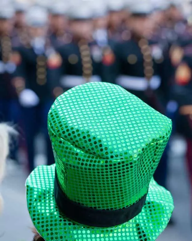 Door County spring events, Close up shot of the back of a sequinned green top hat worn by someone watching the St Patrick's Day Parade in the background