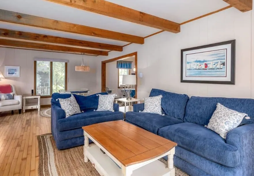 cozy living room with blue sofas at the Family Friendly Retreat in the Heart of Sister Bay, Wisconsin