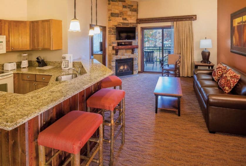 deluxe condo with kitchen, fire place, sofa and balcony at Club Wyndham Glacier Canyon in Baraboo, Wisconsin