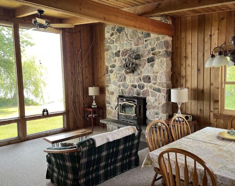 dining area with fire place and lake view at The Lake Cottage in Cedar Grove, Wisconsin