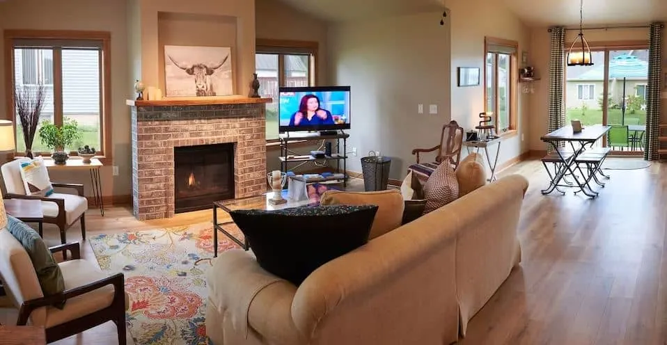 living room with fire place, sofa and dining area at The Shoreline off Lake Michigan in Manitowoc, Wisconsin