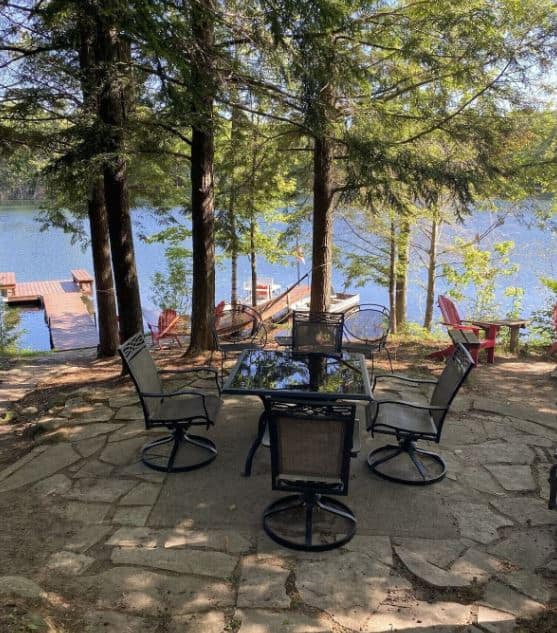 sitting table with chairs with lake views in front of the Relaxing Cabin in Gleason, wisconsin