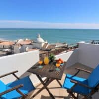 2 chairs and a table on the balcony of the Panoramic Seaview Apartment, Discover top accommodations in Albufeira: beachfront villas, cozy apartments, and luxury resorts for your perfect holiday getaway, best accommodation in albufeira