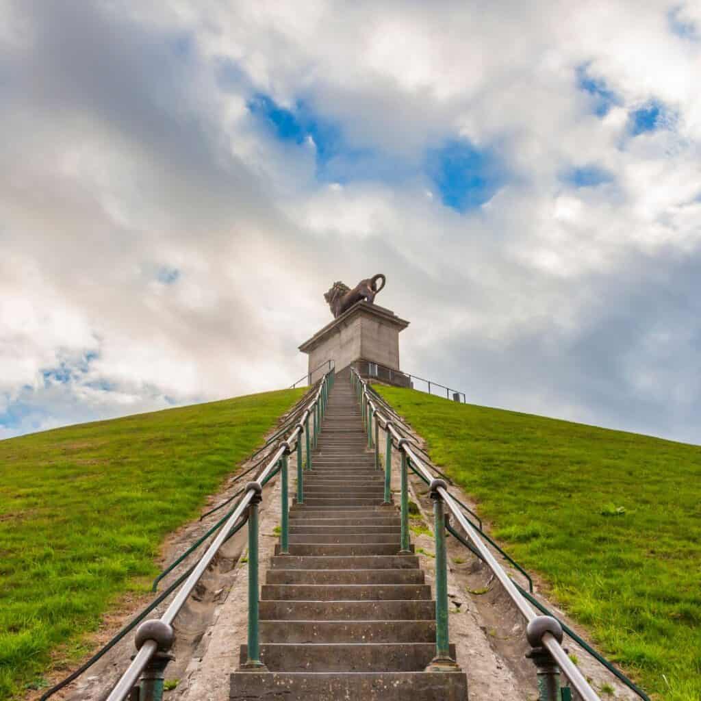 facing upwards, a stairs uphill with a lion monument on top