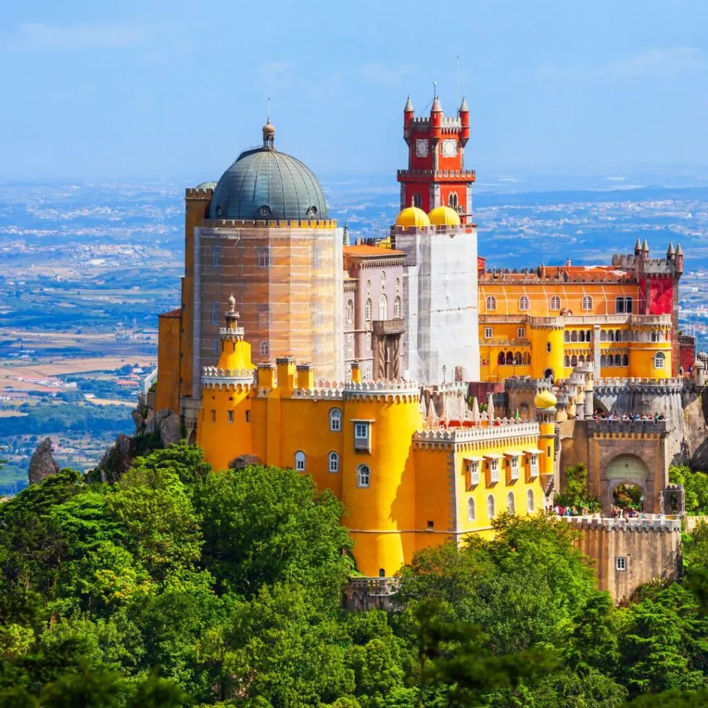 pena castle, sintra, portugal, a castle with yellow walls and blue dome on a blue sky