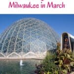 Pin with image of a large glass and metal dome building sat on the banks of a body of water with a fountain in the middle and a series of rocks and plants to one side under a clear sky, caption reads: Wisconsin, Fantastic Things to Do in Milwaukee in March from paulinaontheroad.com