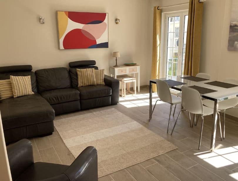 living room with sofa and dining table at Village apartment in Vilamoura, Algarve, Portugal
