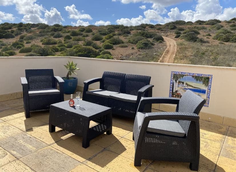 outdoor furniture on the balcony of Luxury Apartment with Pool in Burgau, Portugal