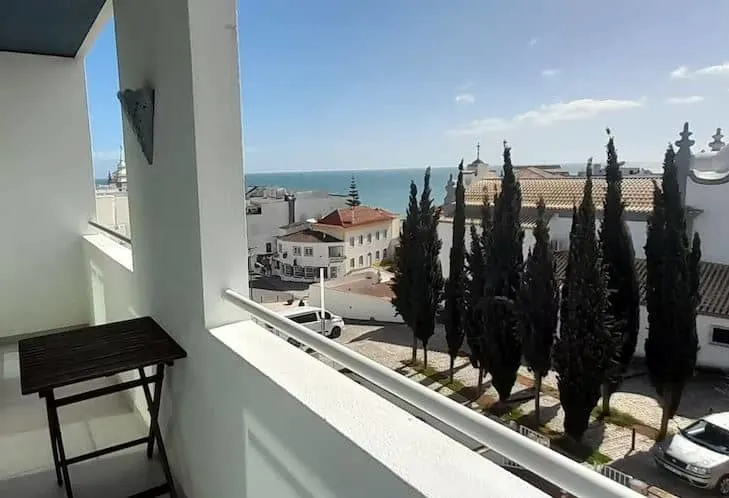 view from the balcony of the bay and trees at the AT THE Bay View Sea View in Old Town in Albufeira, Portugal