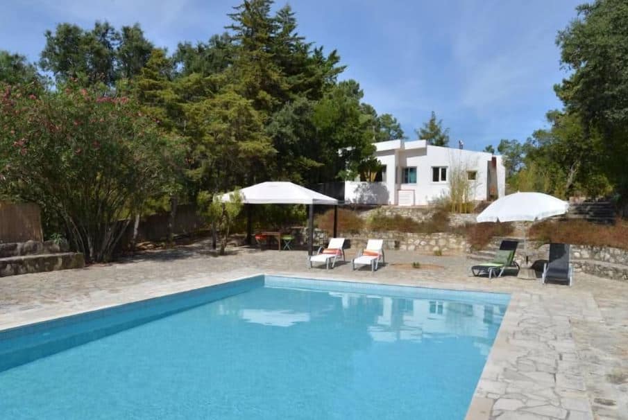 view from the pool of the house and sun lounges at Holiday Beach Villa in Azeitao, Portugal