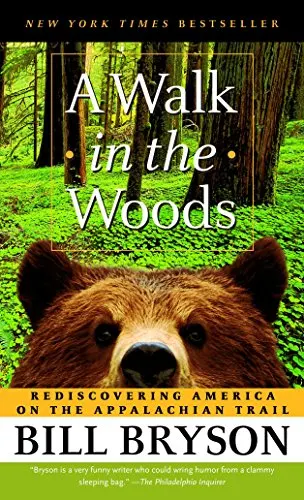 a book cover of A Walk in the Woods with a brown bear peaking and a the woods on the backgroun