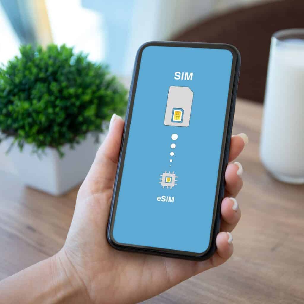 a man holdinga phone with a screen saying sim and esim