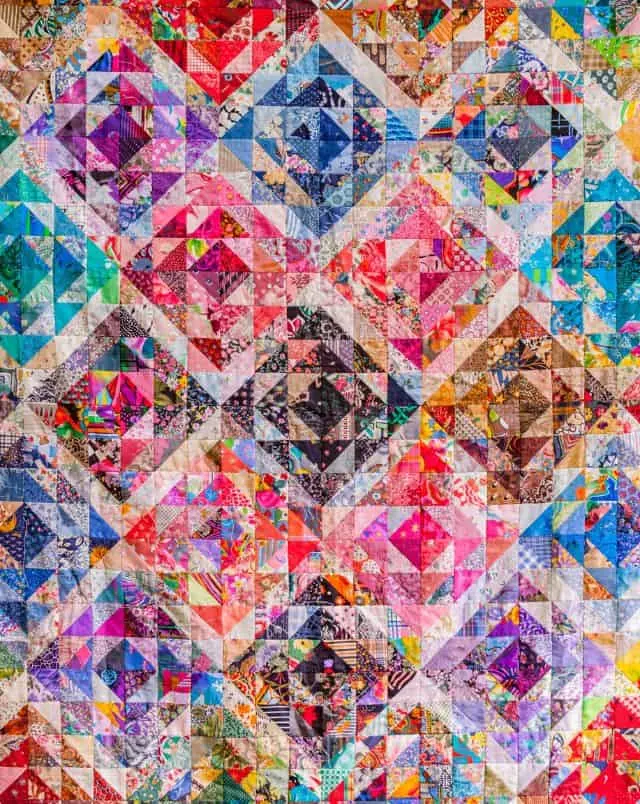 unique things to do in Cedarburg, Colorful patchwork quilt with a design made up of a series of geometric diamond shapes in all the colors of the rainbow