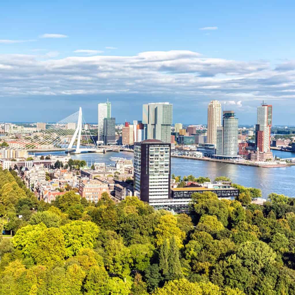 an aerial view of rotterdam netherlands with a buildings and the forest