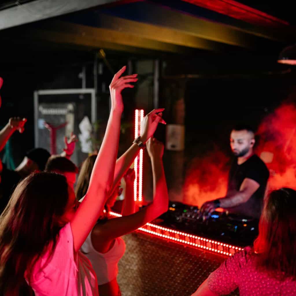 People dancing together in a club with a live DJ, one of top things to do in Albufeira in April