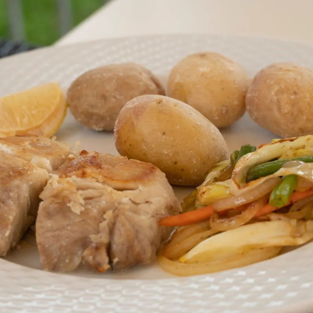 what to do in tenerife in april - eat stew with meat, potatoes, and vegetables