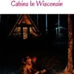 a pin with a couple by the fire in front of one of the most Romantic Secluded Cabins In Wisconsin.