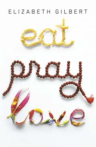 Cover of book titled "Eat, Pray, Love" by Elizabeth Gilbert showing the word "eat" written in pasta and the word "pray" written in prayer beads and the word "love" written in colorful ribbon all on a pplain white background