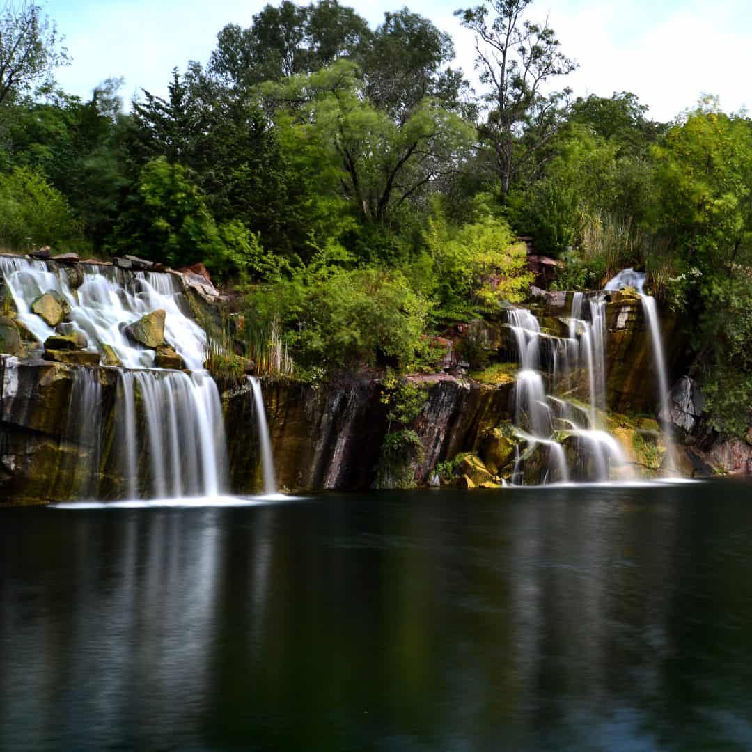 a large waterfall in the middle of a body of water
