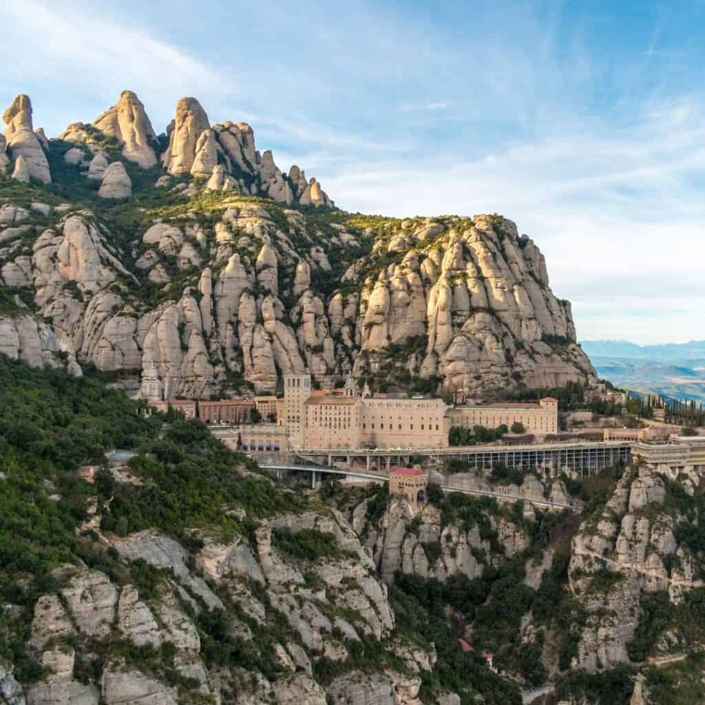 the montserrat monastery by the mountains on a bright day