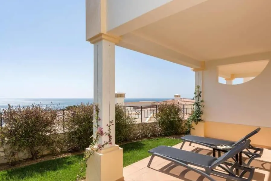 balcony with 2 sun lounges overlooking the sea at NAU Salema Beach Village in Algarve