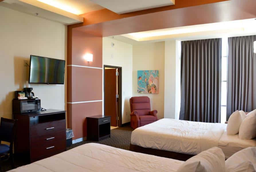 bedroom with 2 separate beds, TV, microwave at the Days Inn & Suites by Wyndham - Milwaukee