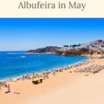Pinterest pin about things to do in Albufeira in May, long stretch of beach with people sunbathing, clear sunny sky, blue waters and white historical buildings in the background