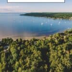 Pinterest pin about places to visit in wisconsin in summer, lush green trees and big lake dotted with small white boats