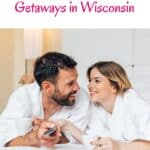 a pin with a couple dressed in bath robes on the bed at one of the best romantic weekend getaways in wisconsin