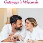 a pin with a couple dressed in bath robes on the bed at one of the best romantic weekend getaways in wisconsin