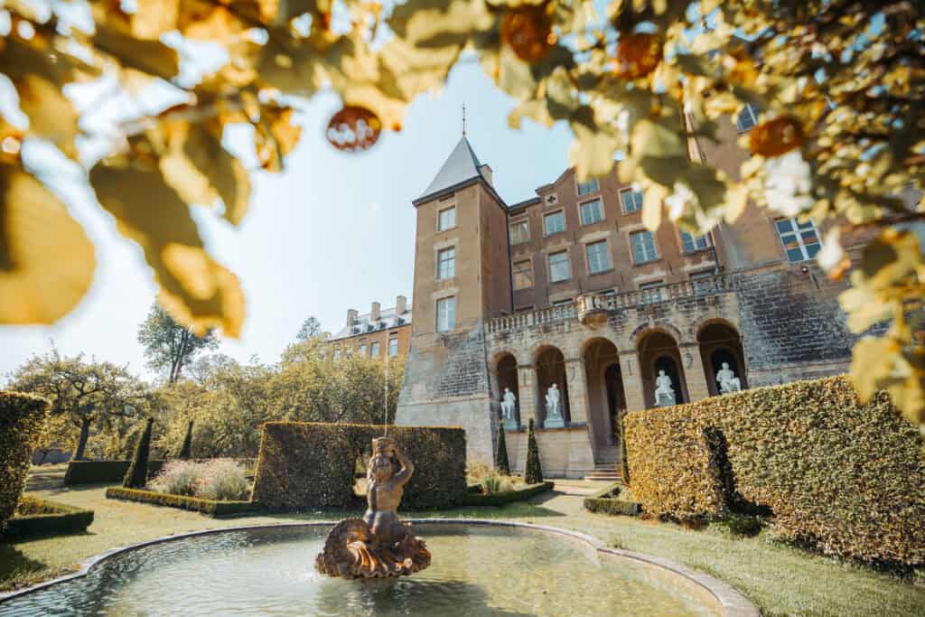 Fountain the gardens of ansembourg castle with fall foliage in luxembourg