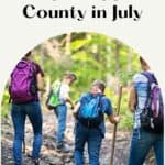 four kids with backpacks trailing on a pathway through the woods