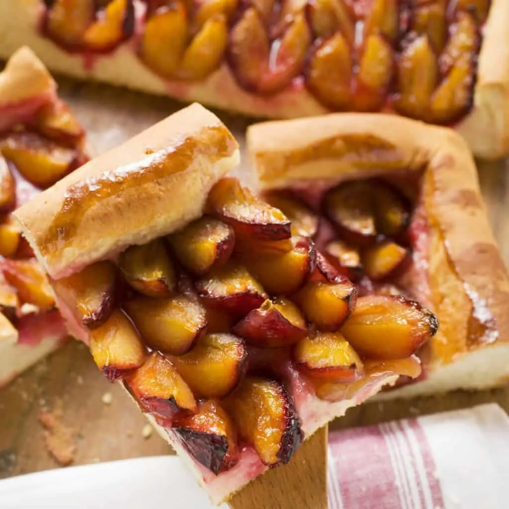 Cut pieces of Quetschentaart, damson plum tart dessert