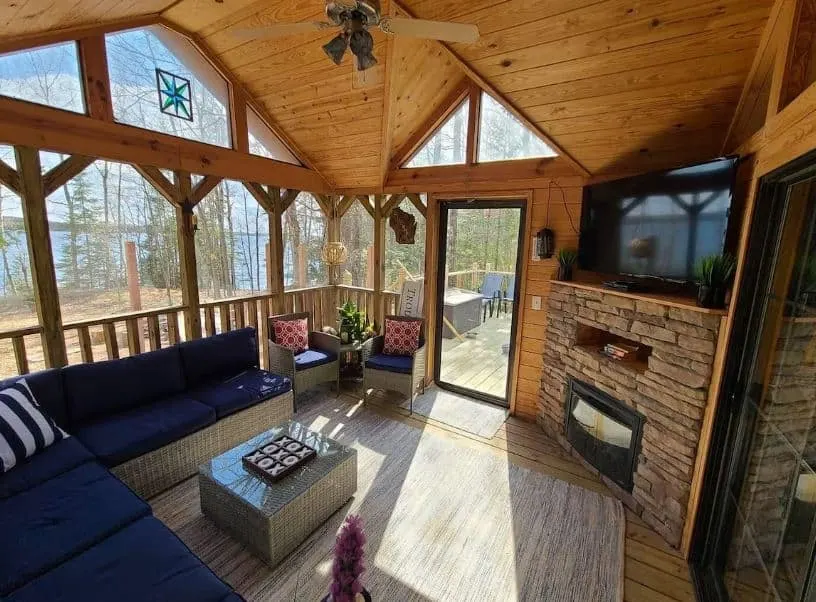 living room with sofa, fire place, TV and lakeview at Tiny Home Big Memories in Phelps, Wisconsin