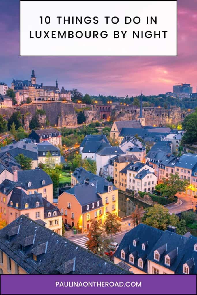Pinterest pin about things to do in luxembourg by night, aerial shot of old town with lights amid a pink sky
