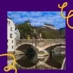 Pinterest pin about things to do in luxembourg, old town with stone bridge with vianden castle in the backdrop