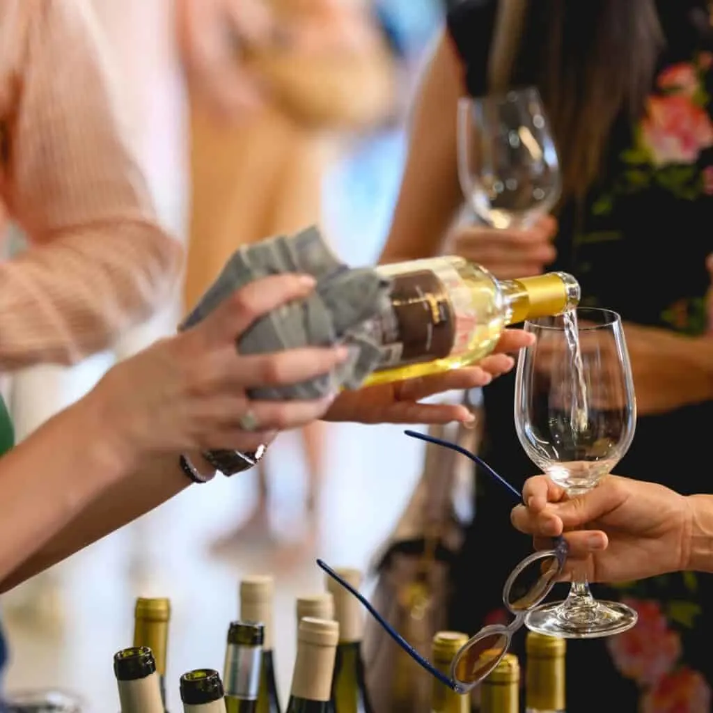 pouring white wine in a wineglass in wine and food festival in lake geneva wisconsin