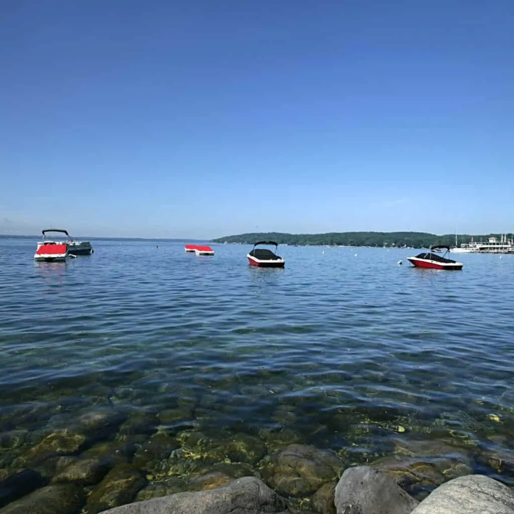 several speedboats docked on the beautiful waters of wisconsin, best things to do in lake geneva in june