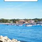 Pinterest pin about things to do in Lake Geneva showing blue lake waters, a smooth paved path, and buildings in the distance during a sunny day