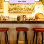 a bar with red stools and gold accent rustic and industrial